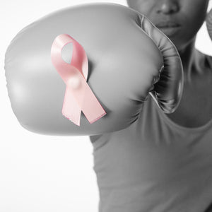 Woman with boxing glove and cancer ribbon